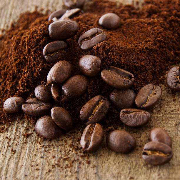 istock Coffee beans and coffee powder as background 1180245789