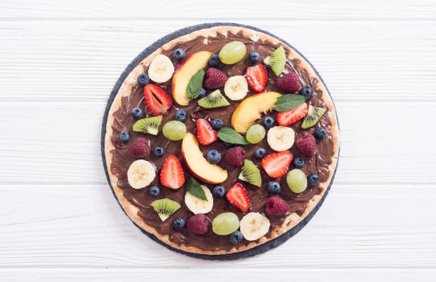 istock Fruit pizza with nut nougat cream , fruit and berries 1180248105
