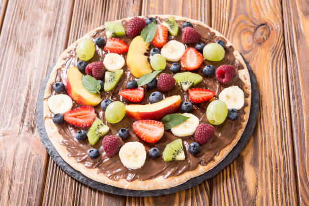 istock Fruit pizza with nut nougat cream , fruit and berries 1180248116
