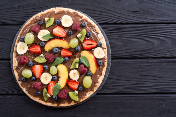 istock Fruit pizza with nut nougat cream , fruit and berries 1180248118