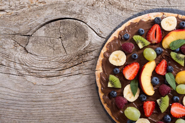 istock Fruit pizza with nut nougat cream , fruit and berries 1180248129