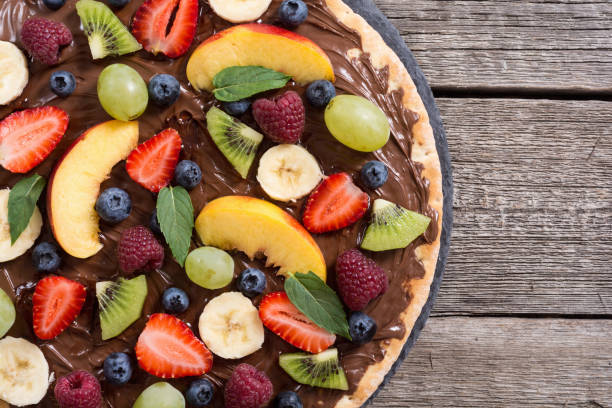 istock Fruit pizza with nut nougat cream , fruit and berries 1180248132