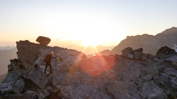 istock Mountaineer crosses summit ridge at sunrise 1180248751
