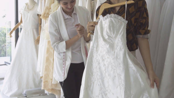 istock Future bride customer talking with wedding store shopkeeper 1180251882