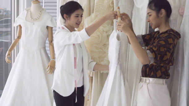 istock Future bride customer talking with wedding store shopkeeper 1180252088
