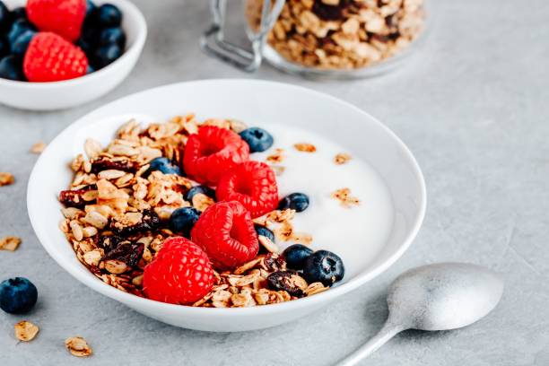istock Healthy breakfast bowl homemade granola with fresh blueberry and raspberry 1180254848