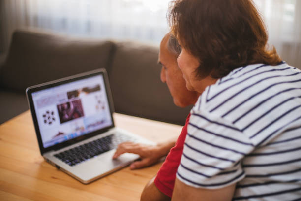 istock Senior couple using laptop at home 1180255647
