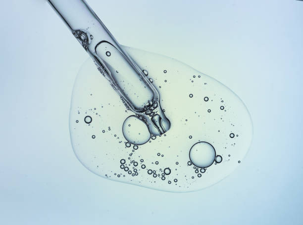 istock Liquid serum gel on a table screen of microscope isolated background 1180256398