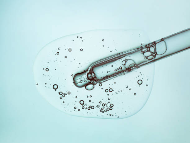 istock Liquid serum gel on a table screen of microscope isolated background 1180256475