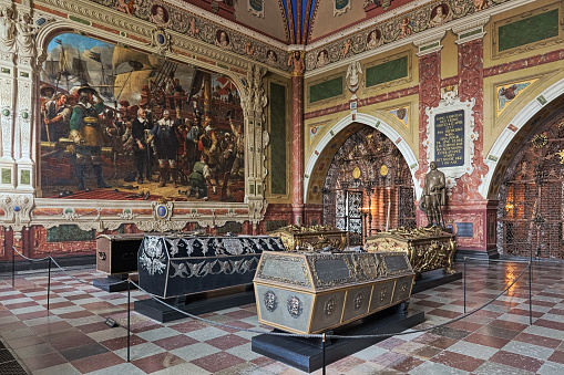 Roskilde, Denmark - December 14, 2015: Interior of Christian IV's chapel in Roskilde Cathedral with the sarcophagi of king Christian IV of Denmark, his wife Anne Catherine of Brandenburg, his sons king Frederick III of Denmark with wife Sophie Amalie of Brunswick-Luneburg, and Christian, Prince-Elect of Denmark. The chapel was built in 1614-1641. The interior of the chapel was completed in 1870 including the frescoes by Heinrich Eddelien, and paintings with decor by Wilhelm Marstrand and Heinrich Hansen. The statue of Christian IV was created by Bertel Thorvaldsen.