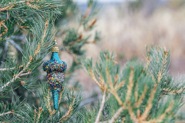 istock Blue Christmas ornament hanging on tree with copy space on the right 1180259130