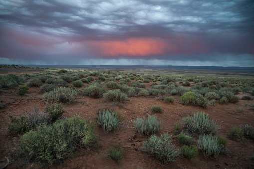 Light from a setting sun casts its colors on clouds from a passing rainstorm in Northern Arizona