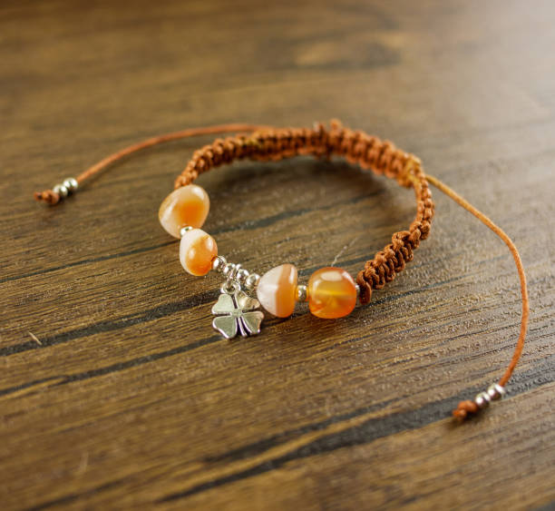 istock Brown bracelet on wooden background 1180263077