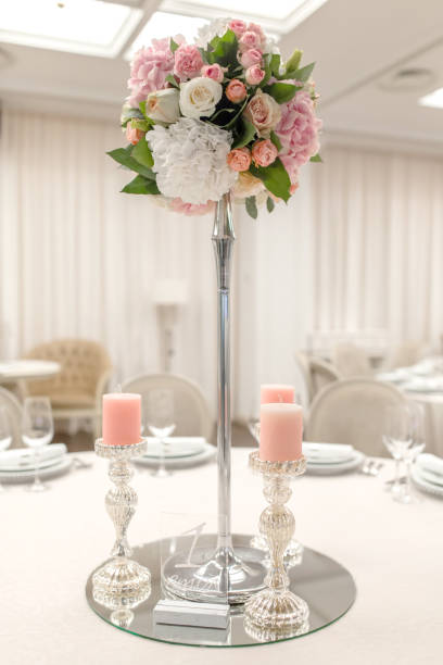 istock Close-up stand for a candlestick and a table number in a restaurant. Event decor 1180264960