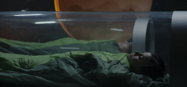 Astronauts sleeping in glass capsules Full shot of a female and a male astronaut sleeping in glass capsules in a Mars station hibernation stock pictures, royalty-free photos & images