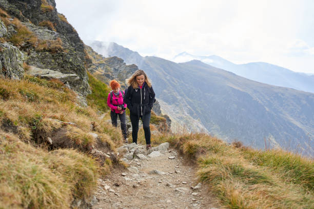 istock Backpacker ladies hiking on a trail 1180266597