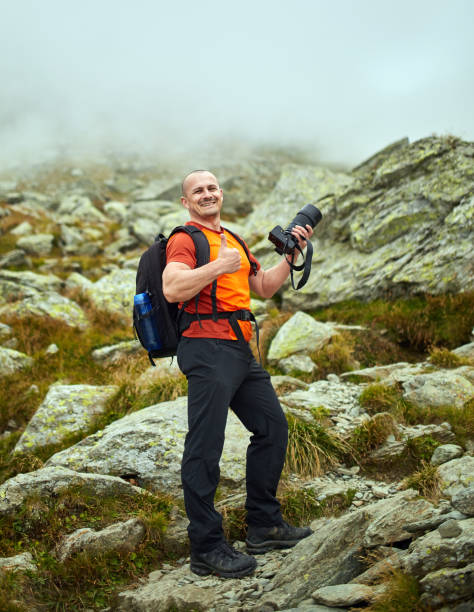 istock Tourist hiking with camera 1180267451