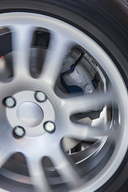istock rotating car wheel and brake disc 1180268098