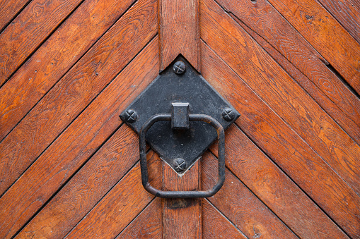 Rusty doorknob or old door handle with wall background