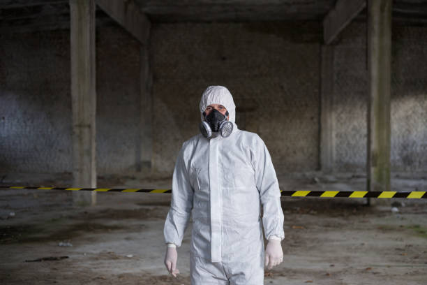 Emergency situations specialist stands inside the building where the accident occurred.