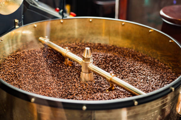 istock Roast machine. The freshly roasted coffee beans from a coffee roaster being poured into the cooling cylinder. 1180270245