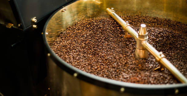 istock Roast machine. The freshly roasted coffee beans from a coffee roaster being poured into the cooling cylinder. 1180270326