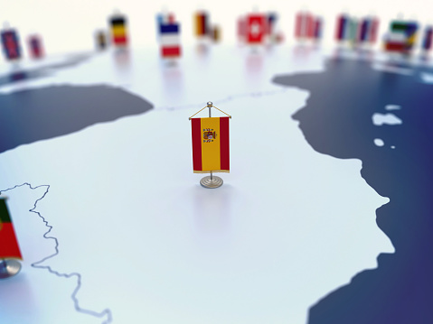 Flag of Spain in focus among other European countries flags. Europe marked with table flags 3d rendering