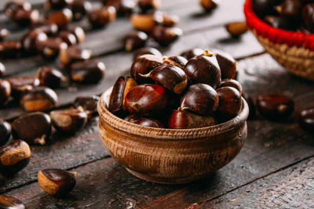 istock Raw Chestnuts on Wooden Table 1180272426