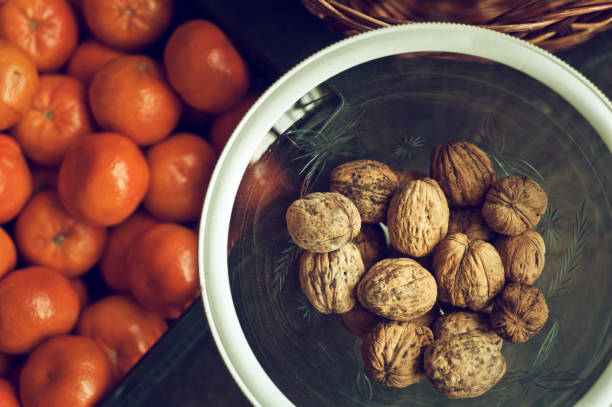 istock Cup of walnuts and fresh clementines 1180273187