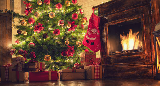 istock Decorated Christmas Tree Near Fireplace at Home 1180273619