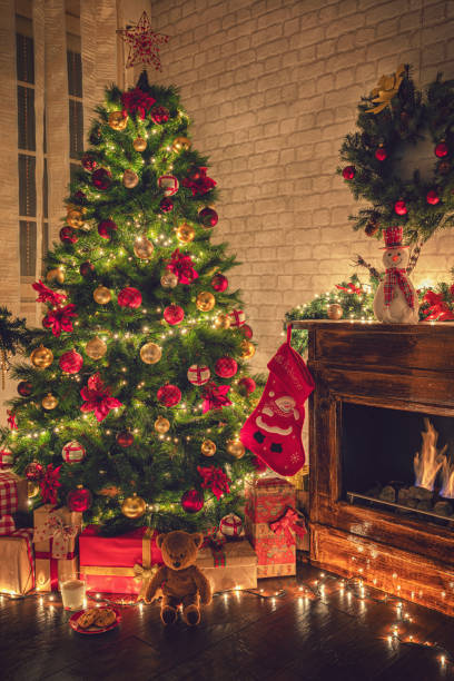 istock Decorated Christmas Tree Near Fireplace at Home 1180273751