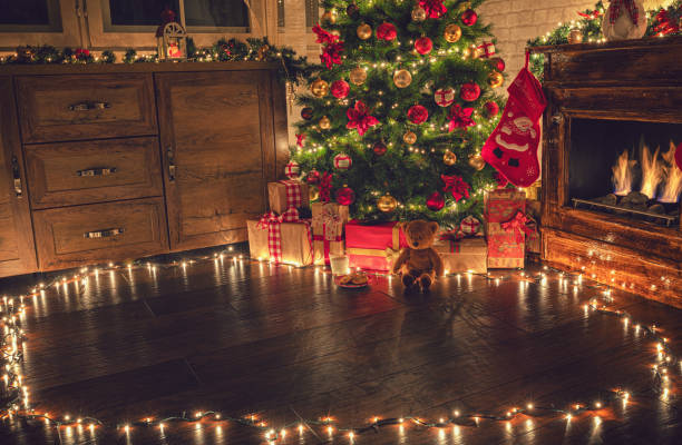 istock Decorated Christmas Tree Near Fireplace at Home 1180273752