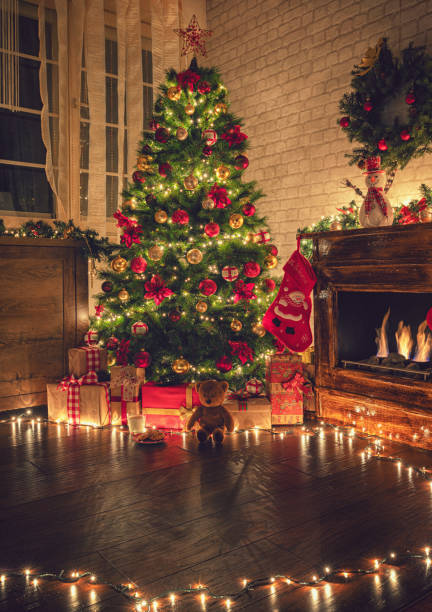 istock Decorated Christmas Tree Near Fireplace at Home 1180273812