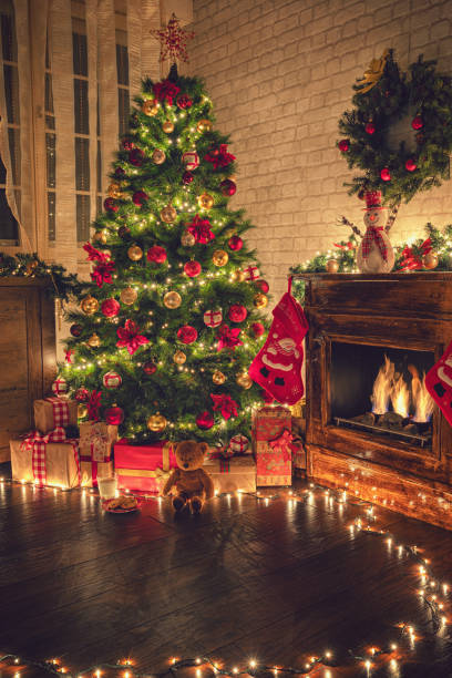 istock Decorated Christmas Tree Near Fireplace at Home 1180273835