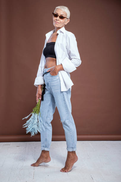 istock Positive delighted senior model standing isolated on brown 1180276696