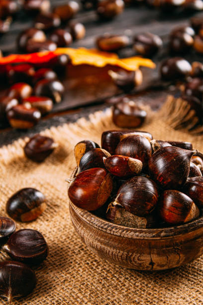 istock Raw Chestnuts on Wooden Table 1180276964