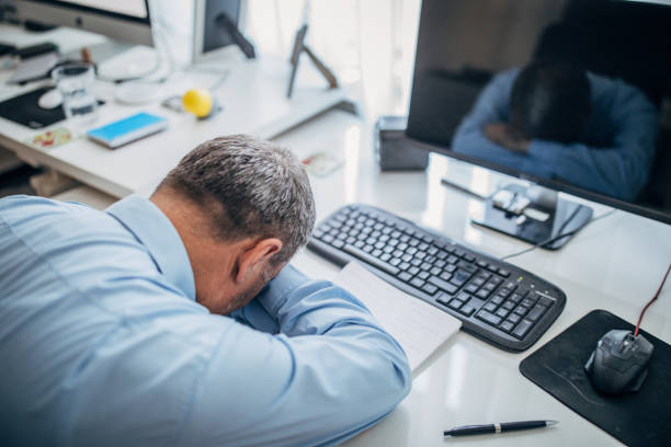 istock Tired senior businessman napping at the office 1180276967