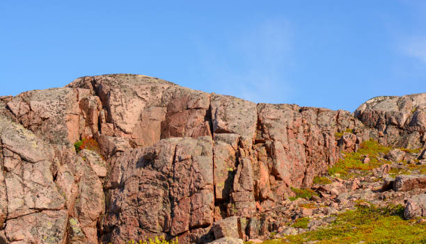 istock Pink colored mountain or hilltop surrounded by green grass and moss. 1180277744