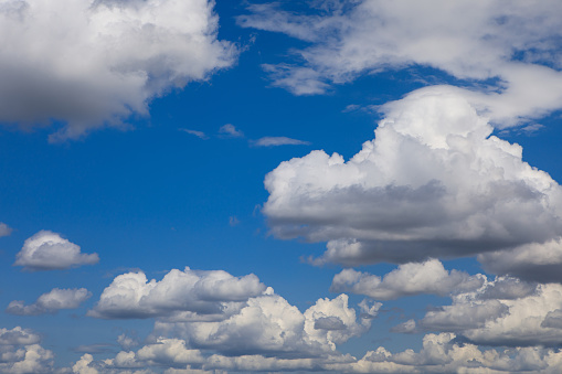 Bright sunny day, cloudscape full of white fluffy cummulus clouds