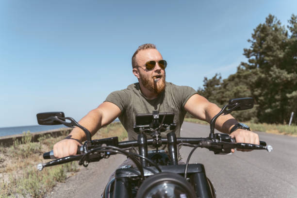 handsome-bearded-man-with-sigar-riding-his-motorcycle.jpg