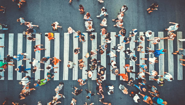 Aerial. People crowd on pedestrian crosswalk. Top view background. Toned image. Aerial. People crowd on pedestrian crosswalk. Top view background. Toned image. directly above stock pictures, royalty-free photos & images