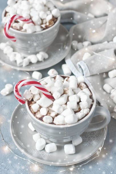 istock Cups of creamy hot chocolate with melted marshmallows and  candy cane 1180279729