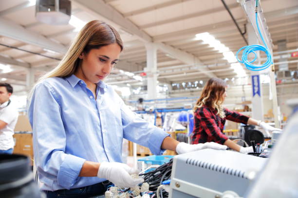 istock Women working in cable factory 1180281846