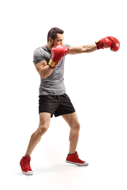 istock Strong young man punching with boxing gloves 1180282965