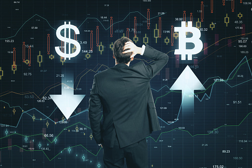 Market and cryptocurrency concept. Back view of thoughtful young businessman making decision on abstract forex chart grid background