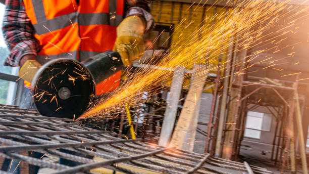 istock Man cutting an iron mesh with an angle grinder 1180285223