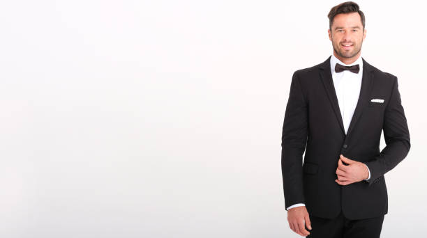 istock Handsome man in classic black suit isolated on white background. 1180286990