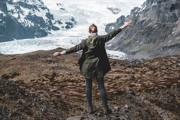 istock Woman standing with arms outstretched 1180287262