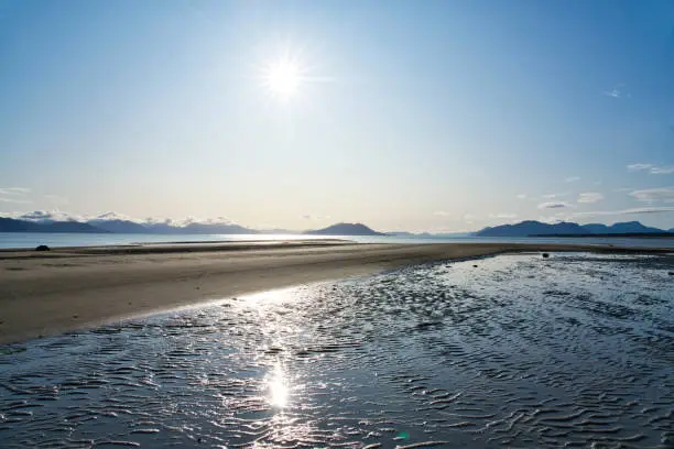Beautiful sunny day at  the beach in Gustavus Alaska with a sunburst.