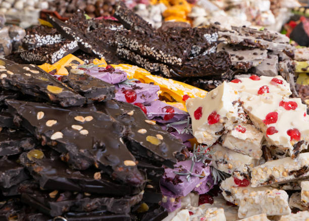 istock Dark, white and colors chocolate pieces crushed and cocoa beans, culinary background 1180288087